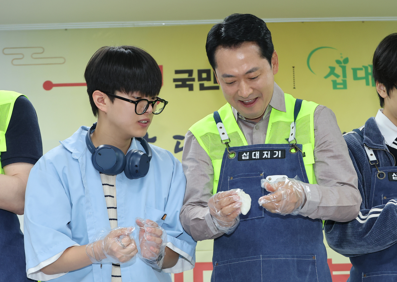 People Power Party leader Jang Dong-hyeok makes rice cakes with youths at a welfare facility in Uijeongbu, Gyeonggi Province, on Wednesday as part of a chuseok volunteer event organized by the party's youth wing, Young Red Wing. [Yonhap]