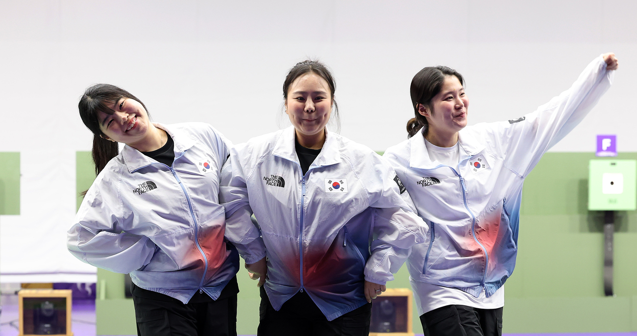 South Korea’s Oh Ye-jin (from left), Kim Bo-mi and Choo Ga-eun, silver medalists in the women’s 10-meter air pistol team event at the 2026 Aichi-Nagoya Asian Games, pose  on the podium at the Aichi Prefectural Shooting Range in Aichi, Japan, on Wednesday. (Yonhap)