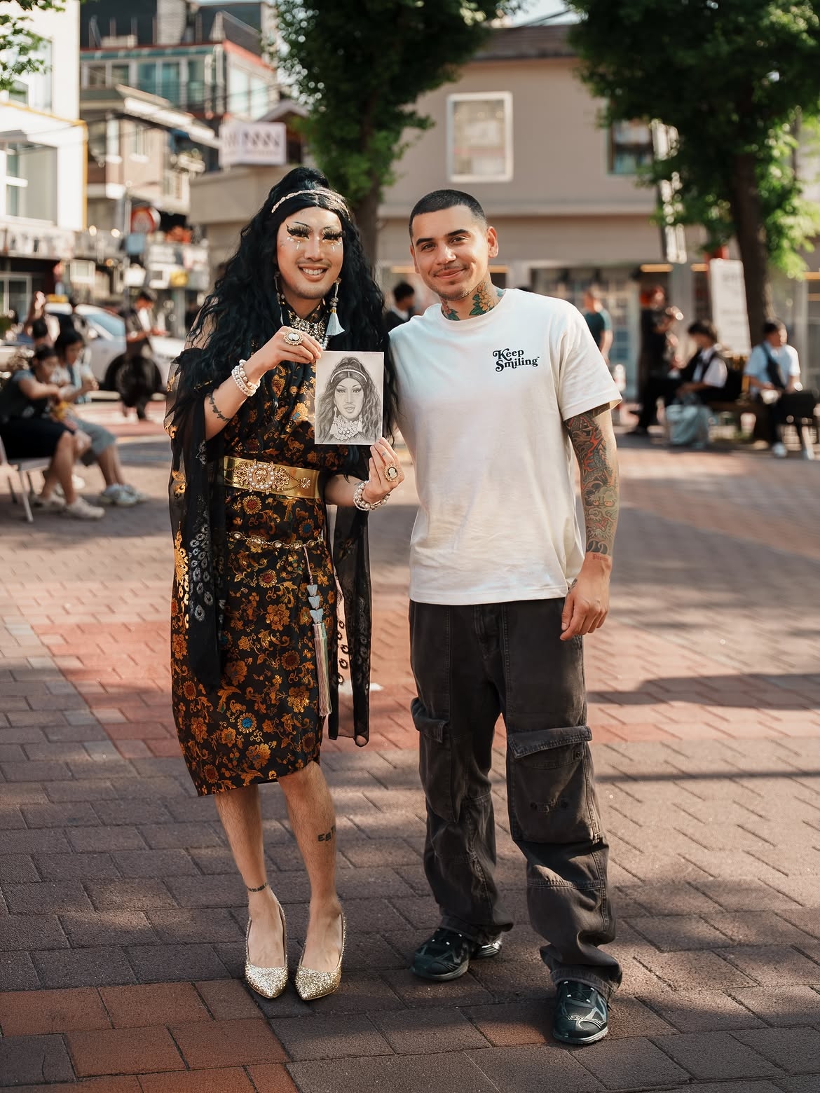Hurricane Kimchi (left) holds up a portrait of herself drawn by Rodriguez (right). (@devonrodriguezart, Instagram)
