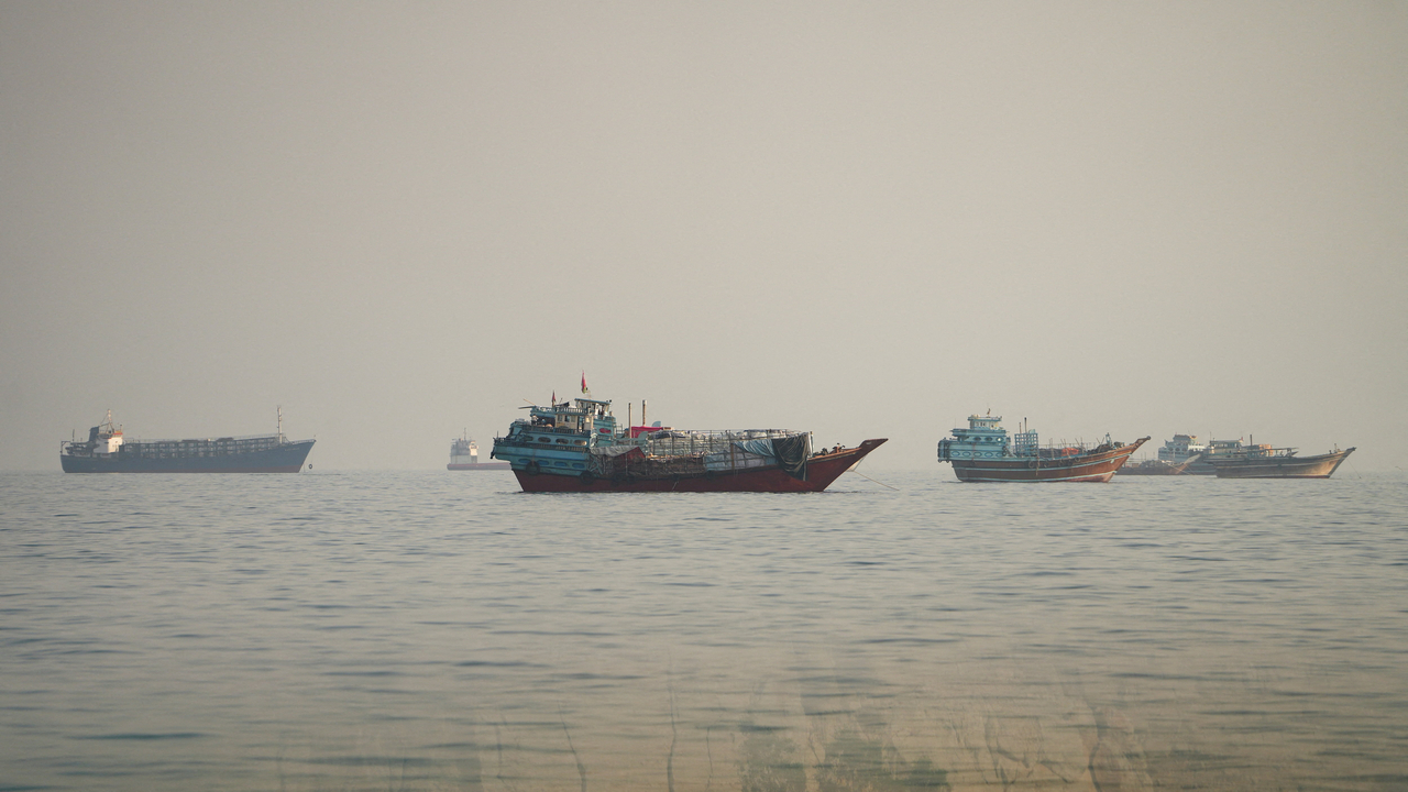 Cargo ships pass through the Strait of Hormuz as seen from Musandam, Oman, on Wednesday (local time). [Reuters]