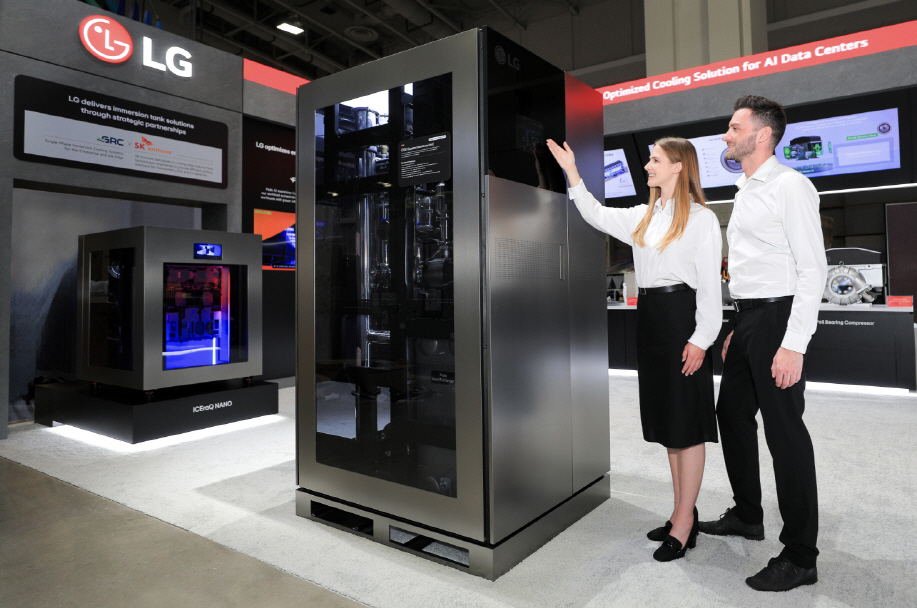 Models pose with LG Electronics’ coolant distribution unit at Data Center World 2026 in Washington in April. (LG Electronics)