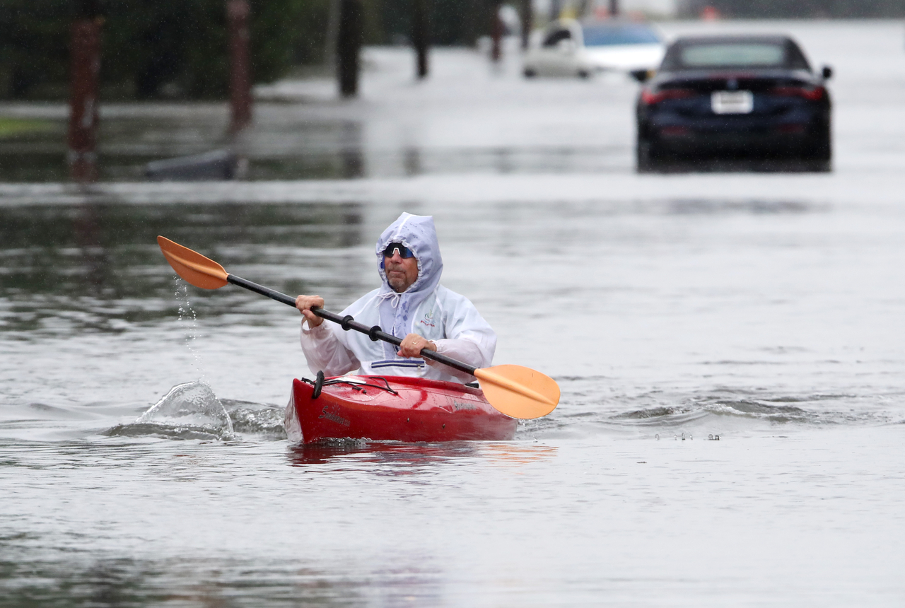 A person kayaks his way through a flooded section in Long Branch, New Jersey, Saturday. (AP-Yonhap)