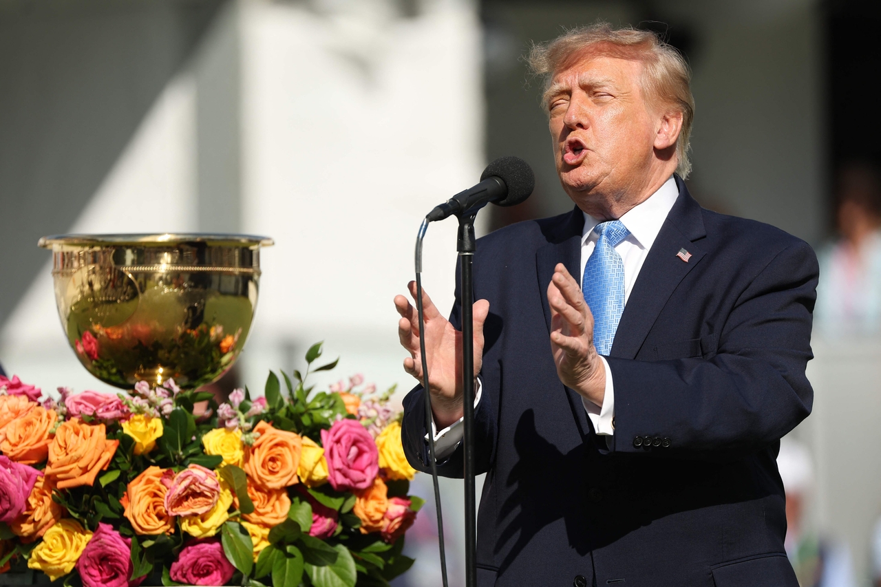 President Donald Trump addresses spectators gathered at the first-hole teeing area during the fourth day of singles matches at the 2026 Presidents Cup at Medina Country Club in Medina, Illinois, on Sunday. [AFP]