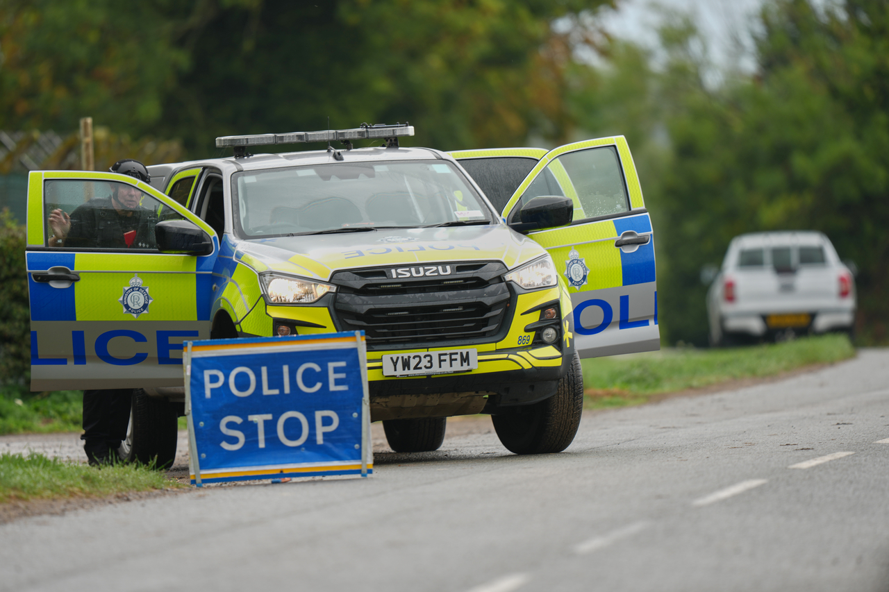 Police stand guard on a road leading to RAF Fairford, a US Air Force base in Fairford, England, on Sunday following the incident. [AP]