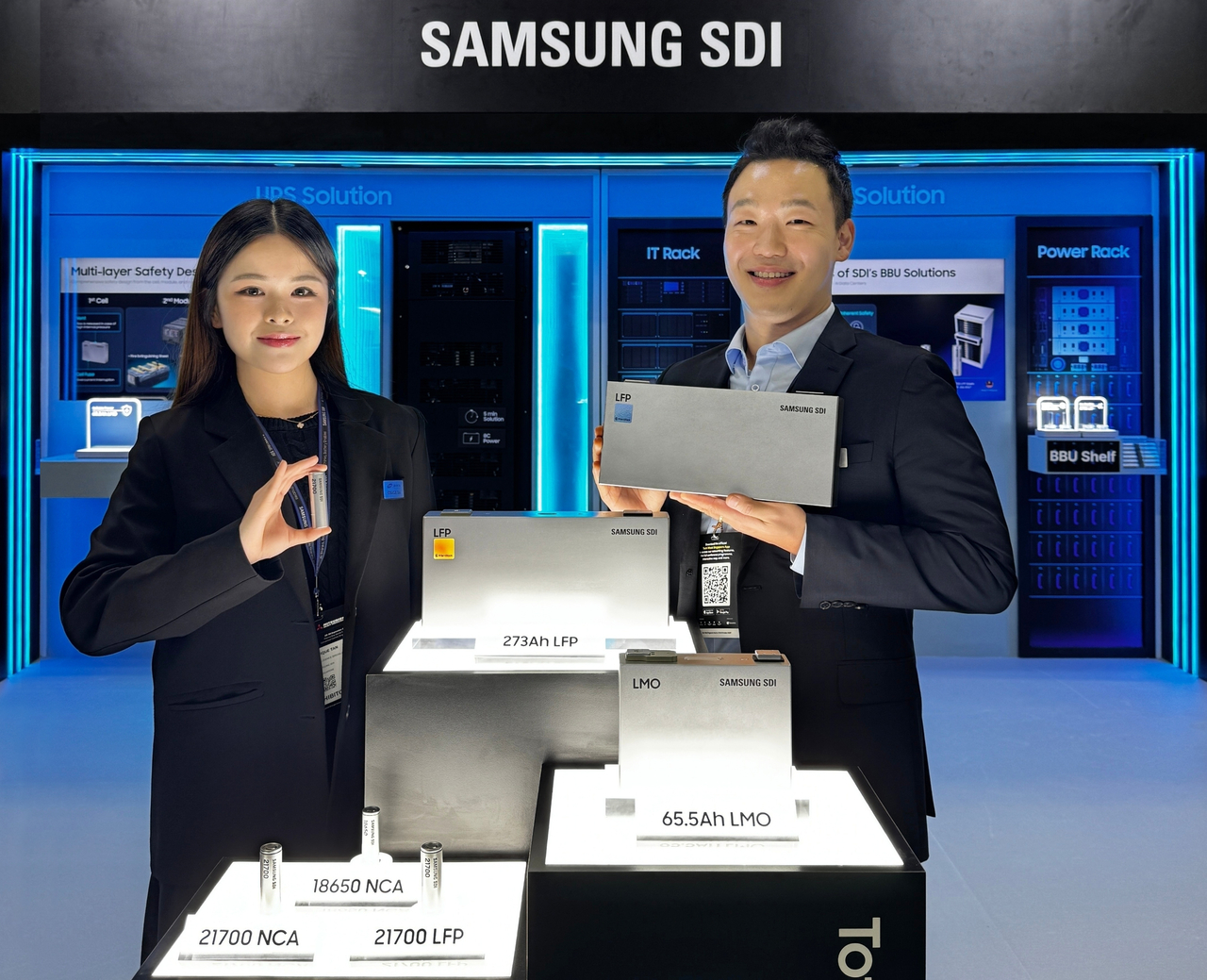 Samsung SDI employees hold the company’s cylindrical and prismatic lithium iron phosphate batteries unveiled at Data Centre World Asia 2026 in Singapore. (Samsung SDI)