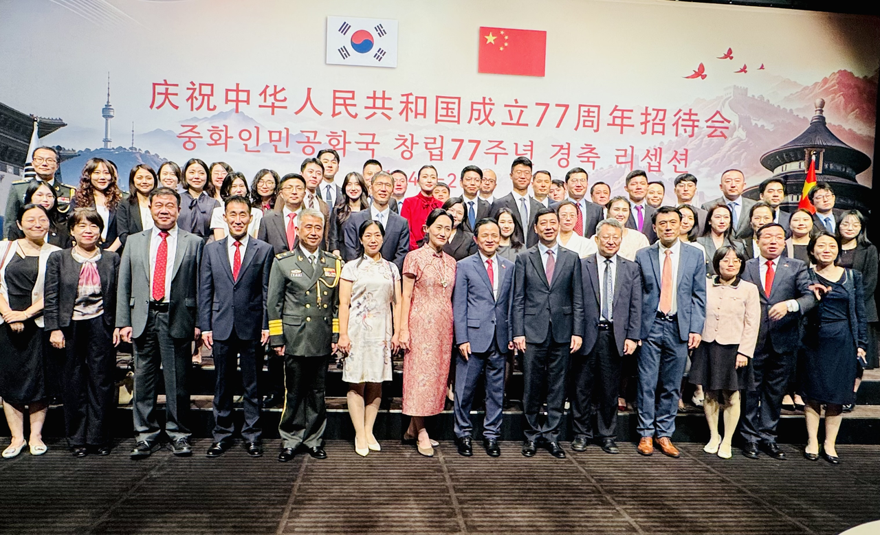 Chinese Ambassador to South Korea Dai Bing (front row, eighth from left) poses for a group photo with embassy officials during celebrations marking the 77th anniversary of the founding of the People's Republic of China on Monday. (Sanjay Kumar/The Korea Herald)