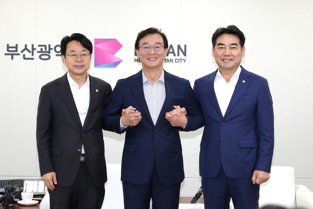 Busan Mayor Jeon Jae-soo (center), Democratic Party of Korea Busan chapter Chairman Park Hong-bae (left) and People Power Party Busan chapter Chairman Lee Seong-gwon hold a ruling-opposition-city hall cooperation conference at Busan City Hall on Wednesday. [Busan city government]