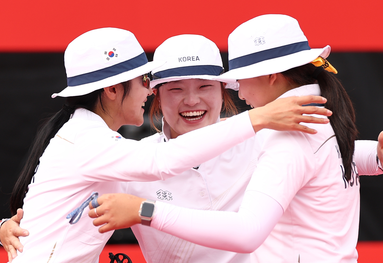 Park Jung-yoon, Park Ye-rin and Kang Yeon-seo of South Korea (from L to R) celebrate after winning bronze in the women's team event in compound archery at the Aichi-Nagoya Asian Games at Okazaki Chuo Sogo Park Multipurpose Square in Okazaki, Japan, on Wednesday. (Yonhap)