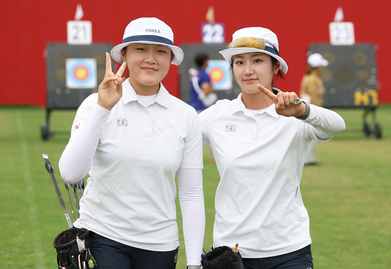Kang Yeon-seo (left) and Park Jeong-yun of South Korea celebrate after advancing to the quarterfinals of the women's EMC individual event at the 2026 Aichi-Nagoya Asian Games at the Okazaki Central General Park multipurpose plaza in Aichi Prefecture, Japan, on Monday. [Yonhap]