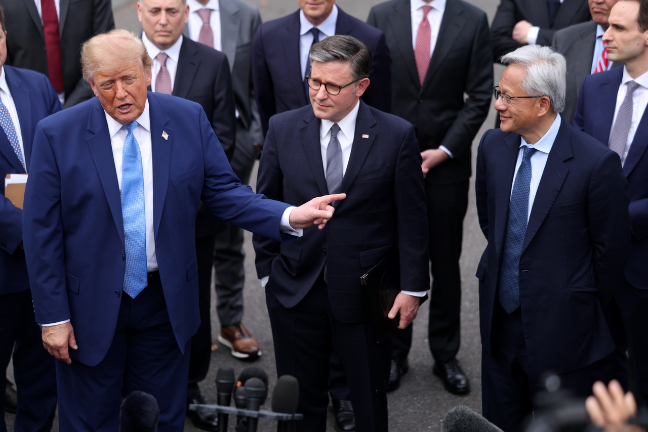 US President Donald Trump (left) speaks to reporters beside US House Speaker Mike Johnson (center) and Nvidia CEO Jensen Huang in Washington on Tuesday. (EPA-Yonhap)
