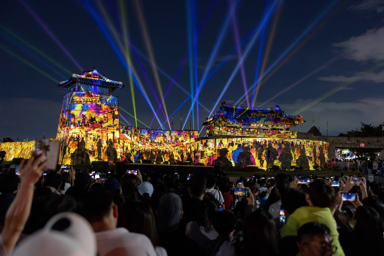 A media art installation at Hwaseomun Gate illuminates the gate and fortress walls during the 2026 Suwon Hwaseong Media Art Festival. (Suwon Special City)