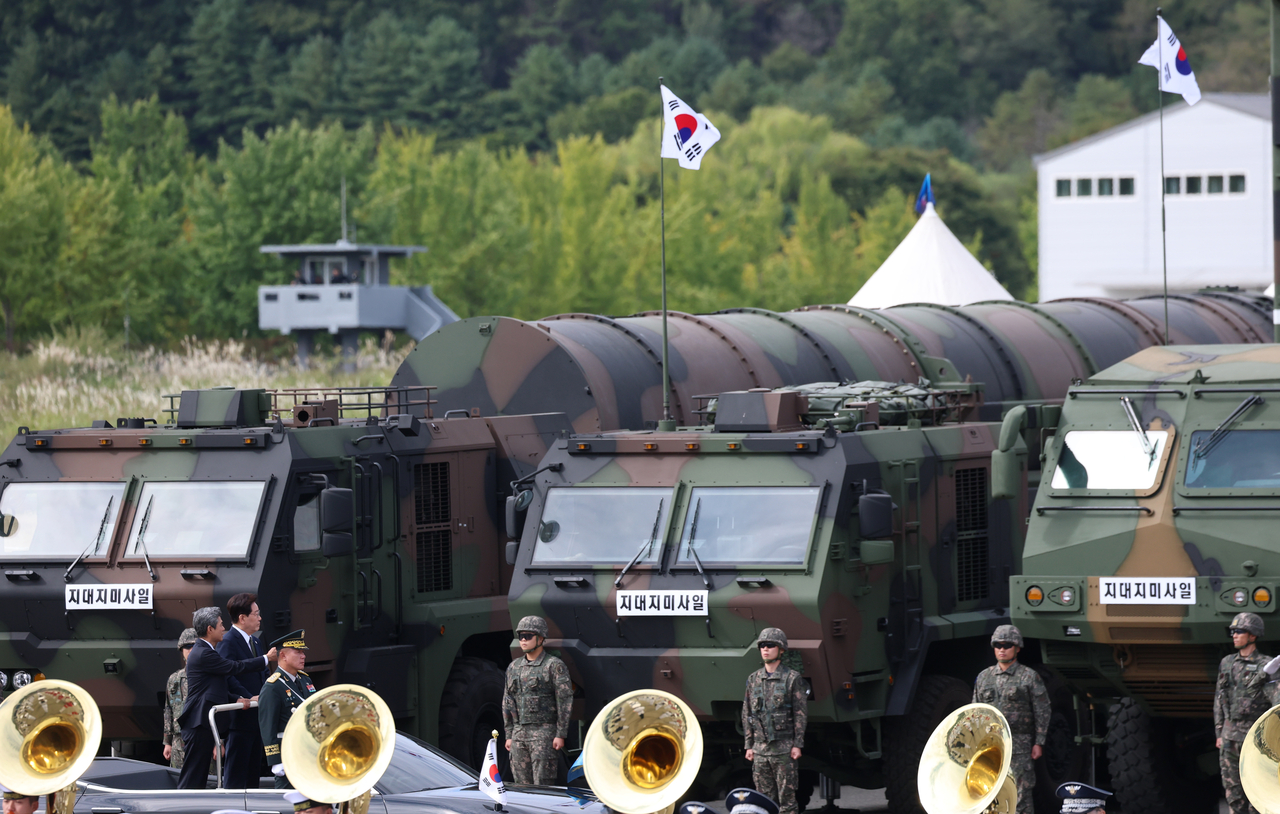 President Lee Jae Myung rides in a review vehicle during a ceremony marking the 78th Armed Forces Day at the Armed Forces headquarters in Gyeryong, South Chungcheong Province, Thursday, with a Hyunmoo-5 missile seen in the background. (Yonhap)