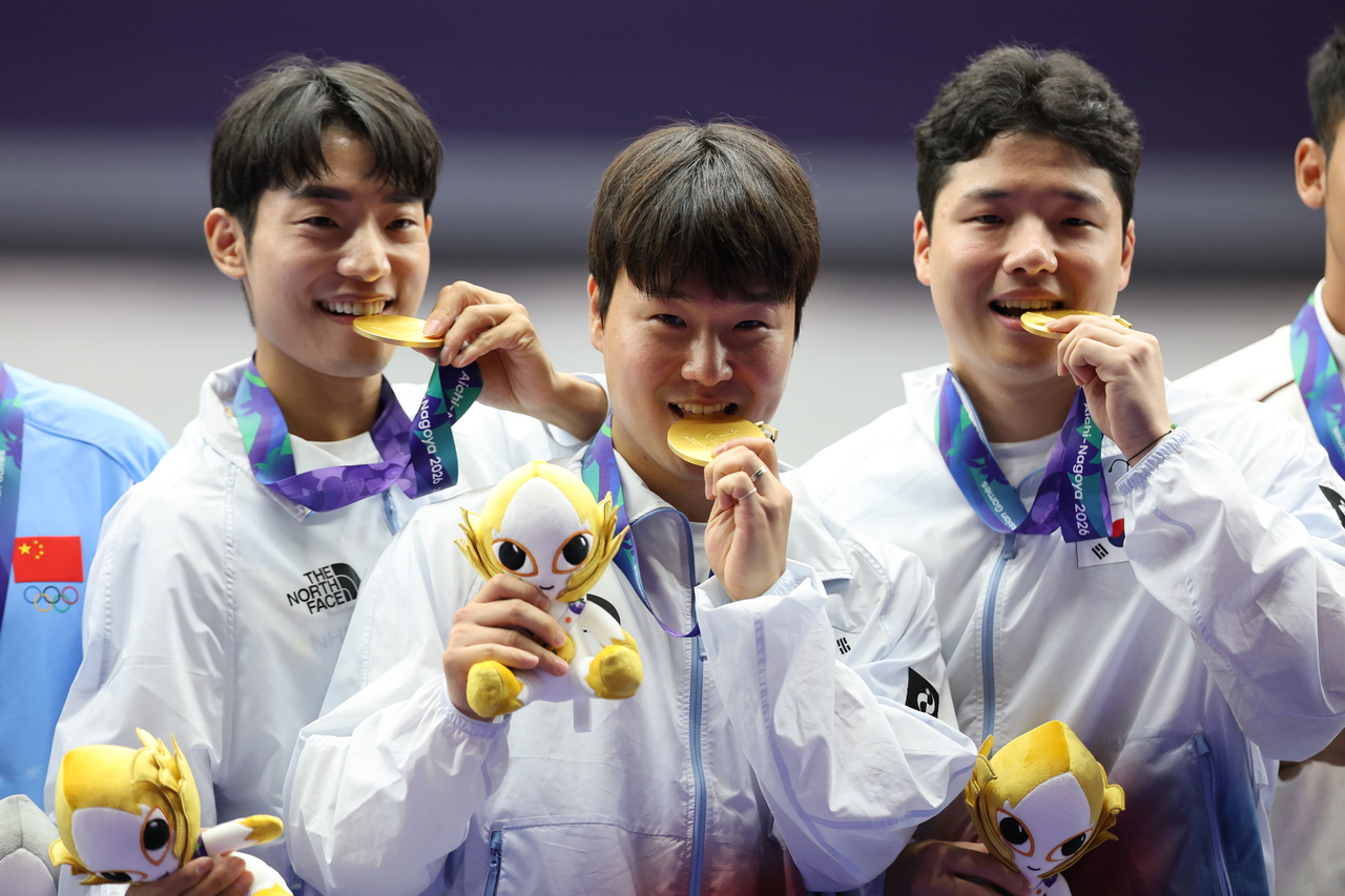 South Korea's Lee Geon-hyeok, Yun Seo-young and Song Jong-ho pose on the podium after winning gold in the men's 25m rapid-fire pistol team event at the 2026 Aichi-Nagoya Asian Games at the Aichi Prefectural General Shooting Range in Toyota, Aichi Prefecture, Japan, on Thursday. [Yonhap]