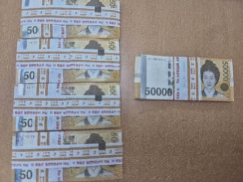 Bundles of 50,000 won bills totaling 25 million won ($18,500), found in a trash bag in Incheon in February, were handed over to the finder after the owner failed to claim the money within six months of a police notice. (Incheon Jemulpo Police Station)