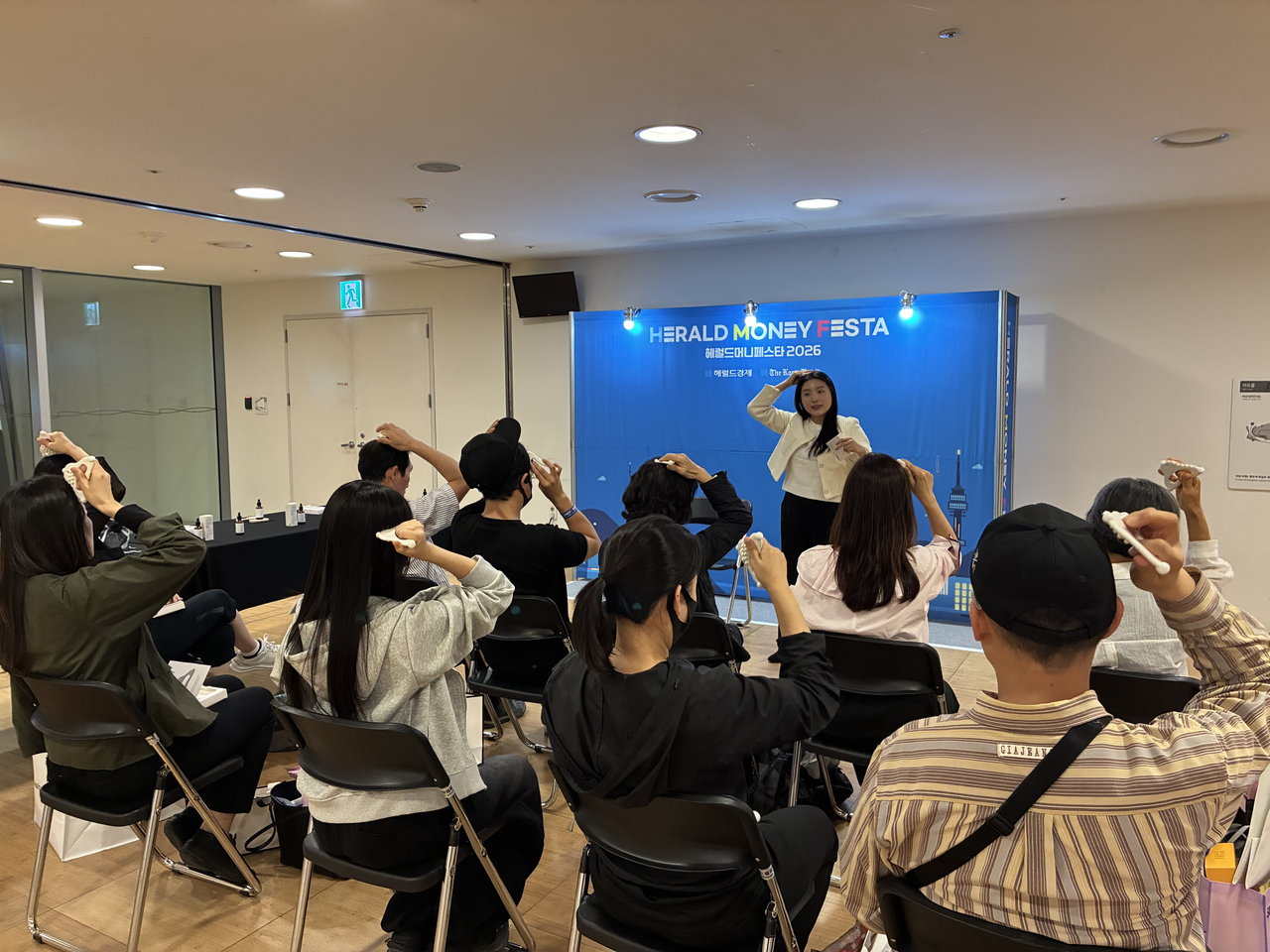 Visitors learn how to use a gua sha tool at Herald Money Festa 2026, held Friday at Dongdaemun Design Plaza in Jung-gu, Seoul.