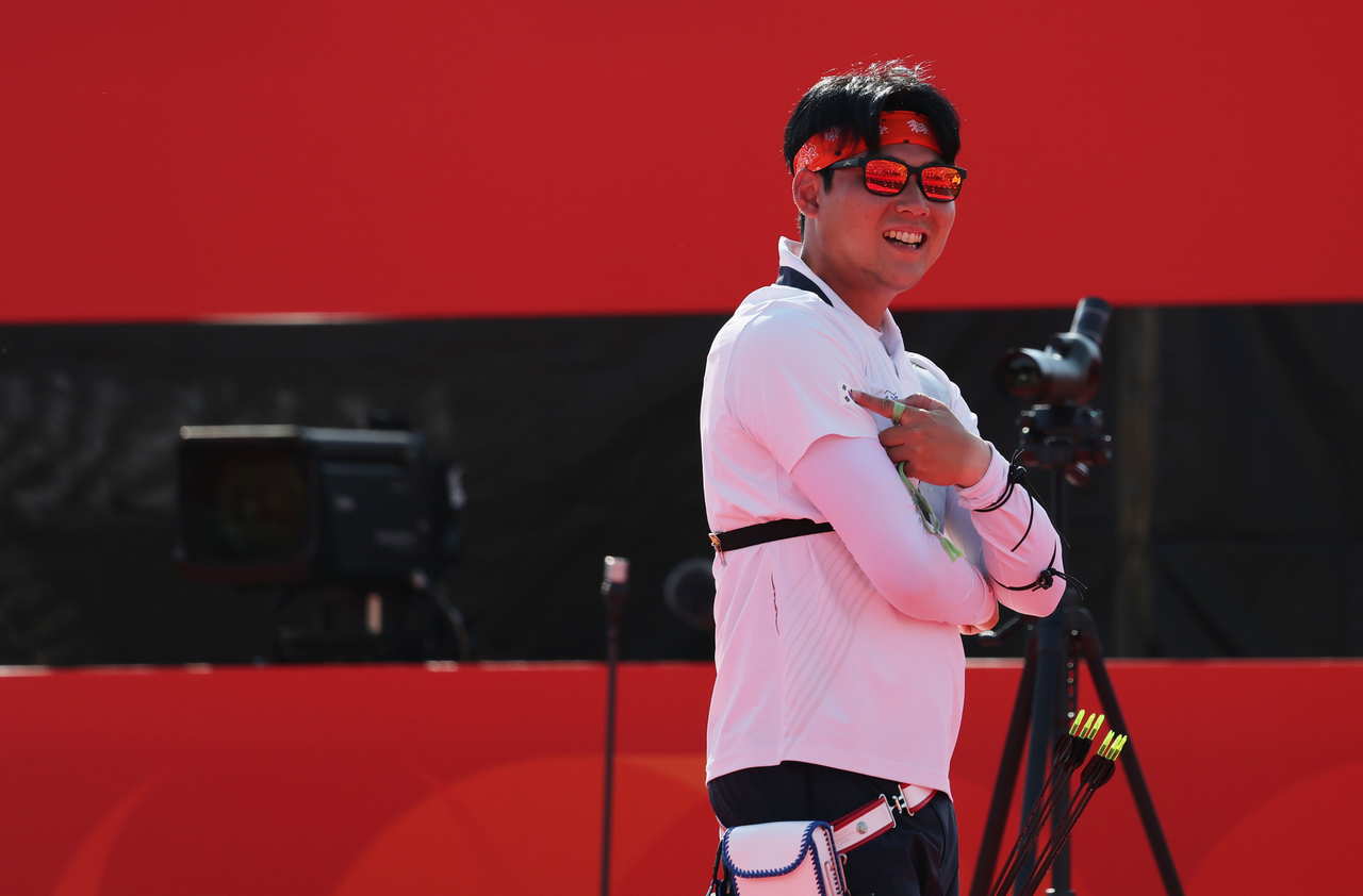 Lee Woo-seok of South Korea points to the national flag, Taegeukgi, on his uniform after winning gold in the men's individual event in recurve archery at the Aichi-Nagoya Asian Games at Okazaki Chuo Sogo Park Multipurpose Square in Okazaki, Japan, on Oct. 3, 2026. (Yonhap)