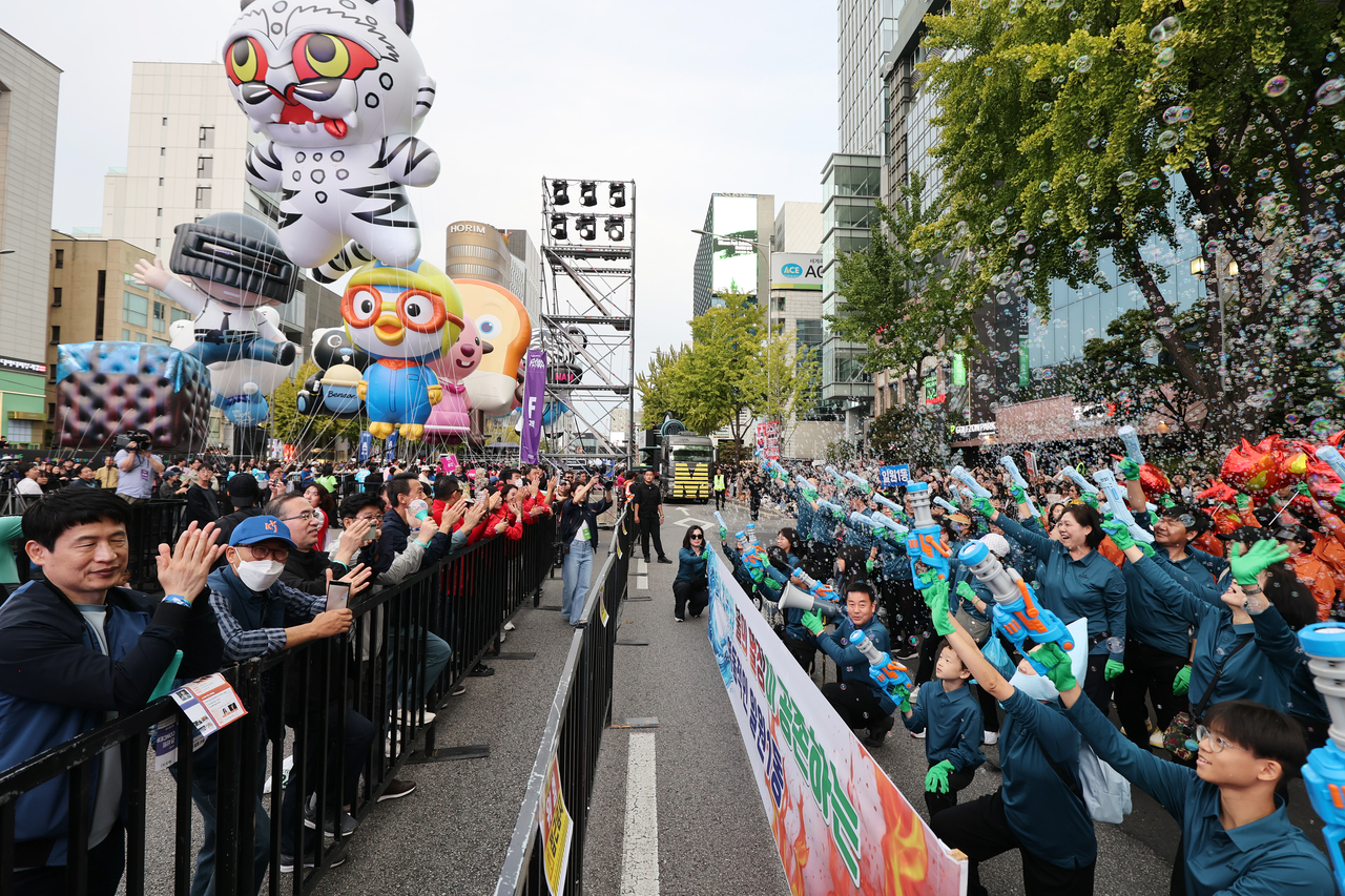 Participants march in the street parade along Dosandaero during the 2026 Gangnam Festival.