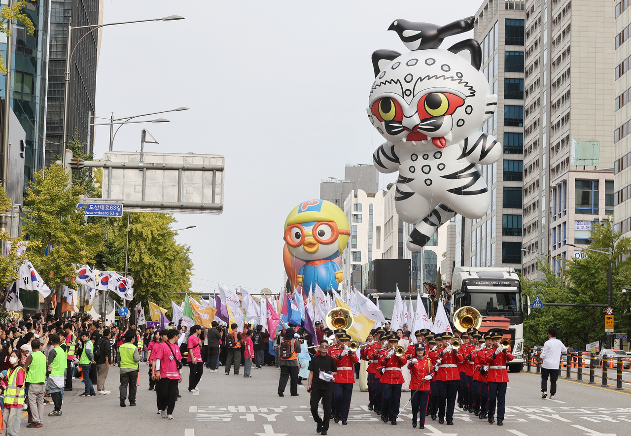 Residents and performers march in the Grand Parade along Dosandaero during the 2026 Gangnam Festival.