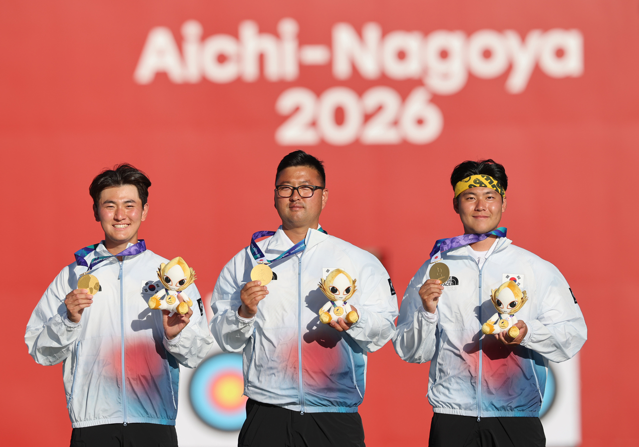 Kim Je-deok, Kim Woo-jin and Lee Woo-seok (from left to right) stand on the podium after winning gold in the men's team event in recurve archery at the Aichi-Nagoya Asian Games at Okazaki Chuo Sogo Park Multipurpose Square in Okazaki, Japan, on Oct. 2, 2026. (Yonhap)