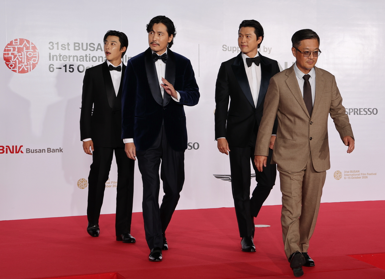 From right: director Woo Min-ho and actors Hyun Bin, Jung Woo-sung and Woo Do-hwan of "Made in Korea" walk the red carpet. (Yonhap)