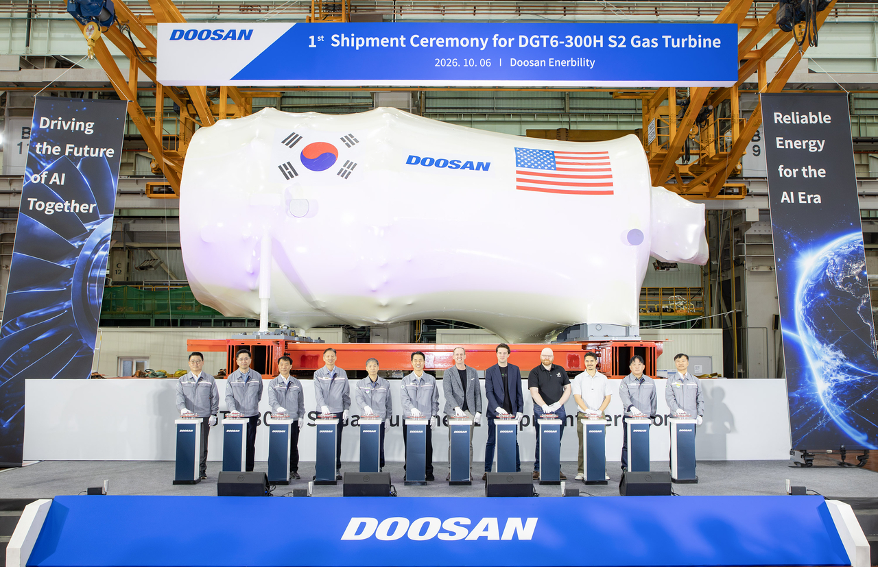 Key representatives from SpaceXAI and Doosan Enerbility employees, including Power Service Business Group Head Son Seung-woo (center), pose for a photo at a shipment ceremony for the 380 MW gas turbine held Tuesday at Doosan Enerbility's headquarters in Changwon. [Doosan Enerbility]