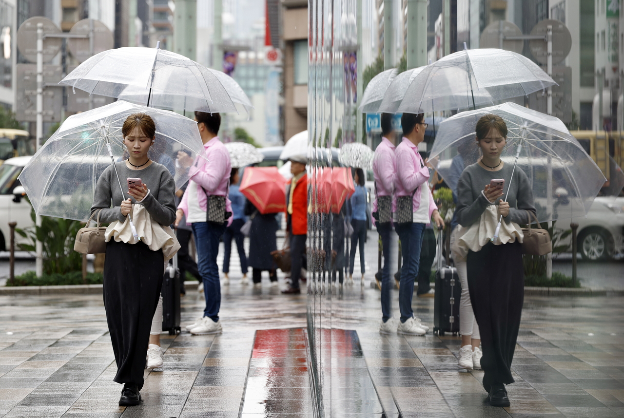 Three typhoons converge on Japan as holiday travelers grow anxious