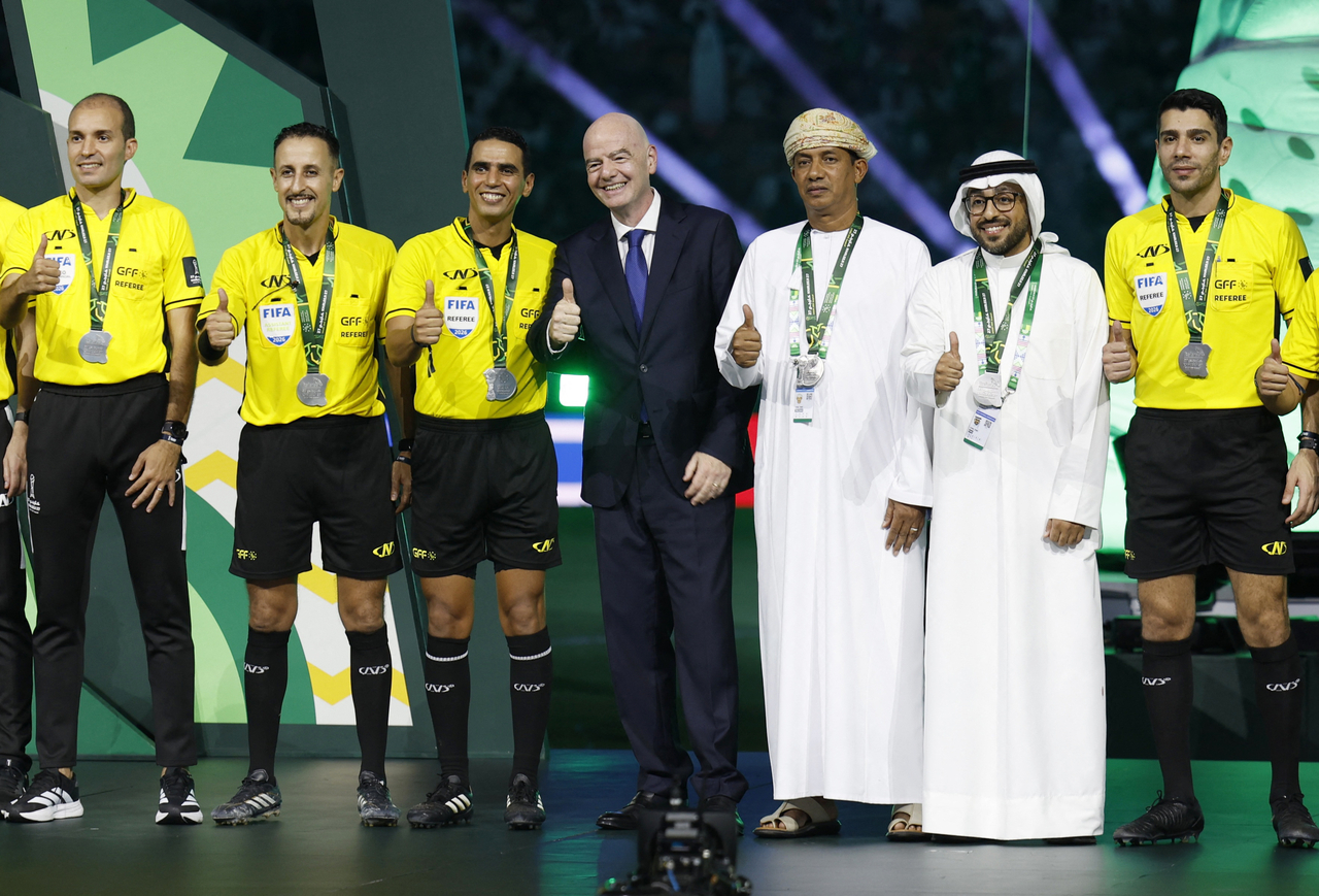 FIFA president Gianni Infantino (center) poses for pictures with the match referees, at the trophy ceremony of the Gulf Club, at King Abdullah Sports City Stadium in Jeddah, Saudi Arabia, Tuesday.    (Reuters-Yonhap)