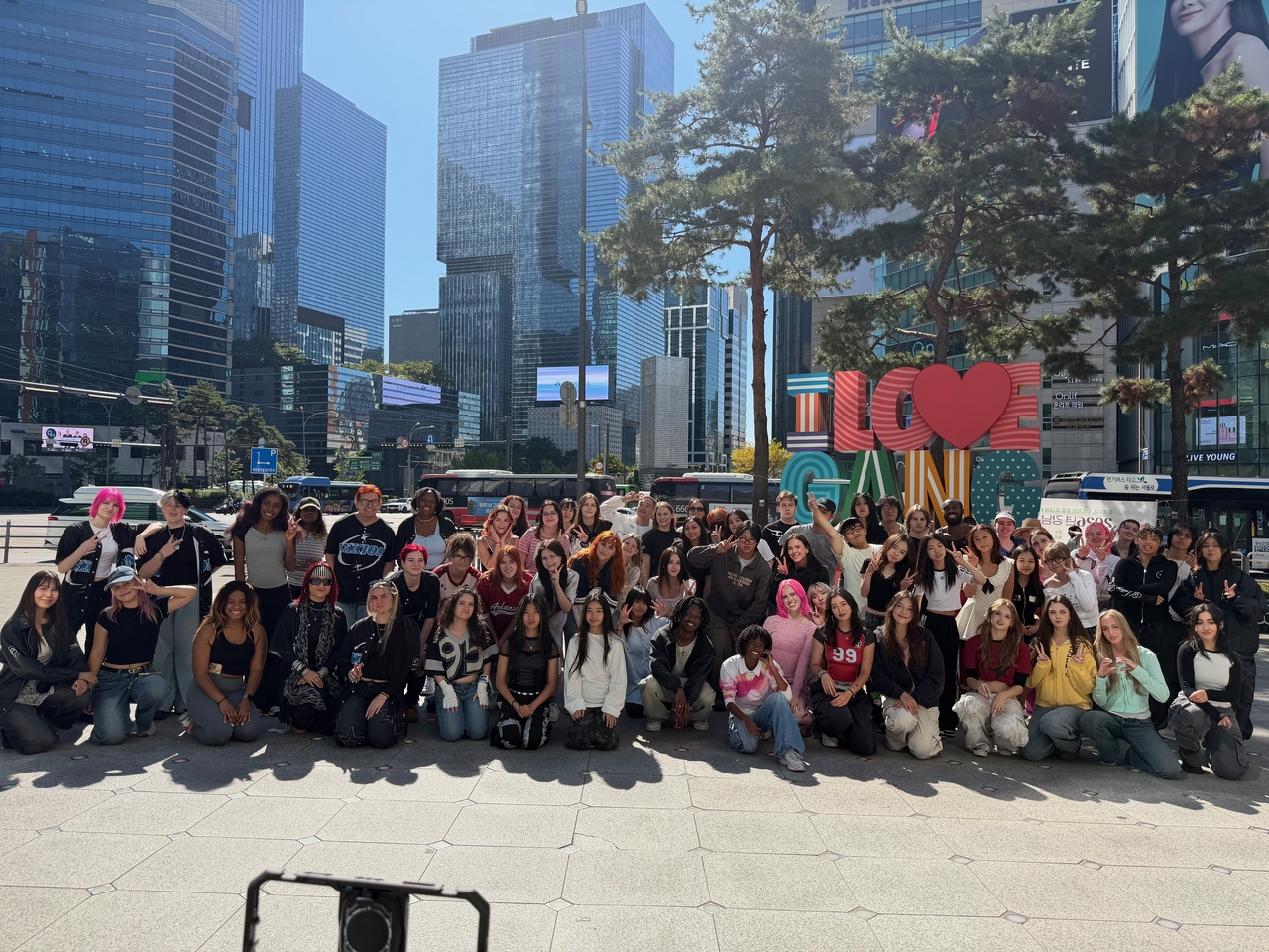 Nine US-based K-pop cover dance teams pose for a group photo after busking at Gangnam Square in Seoul as part of their itinerary for the 2026 Gangnam Festival. The teams flew to Seoul to participate in the festival’s Global K-Pop Cover Dance Championship and related events on Oct. 3-4. (ArtLab J)