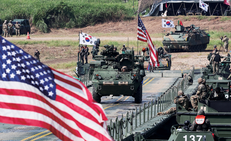 A US Forces Korea Stryker armored vehicle and a South Korean Army K200 armored personnel carrier cross a pontoon bridge during a combined arms river-crossing exercise on the South Han River in Yeonyang-dong, Yeoju, Gyeonggi Province, in August.