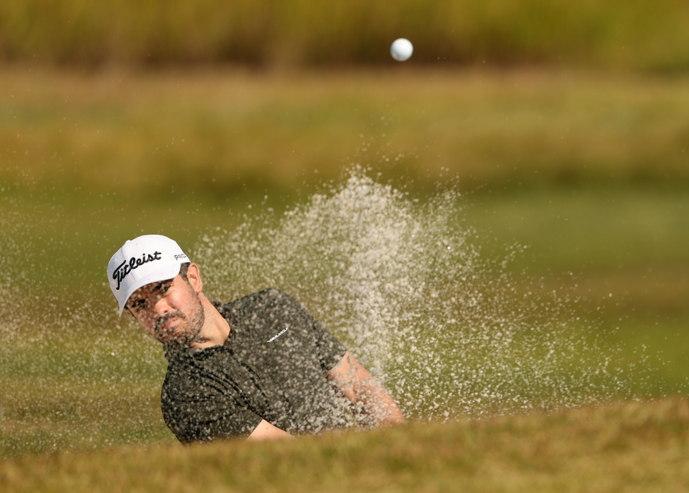 Brandon Kewalamanee plays a bunker shot on the first hole during the third round of the KPGA Tour's Amazing Cree Open at Flamingo Country Club in Dangjin, South Chungcheong Province, on Saturday.