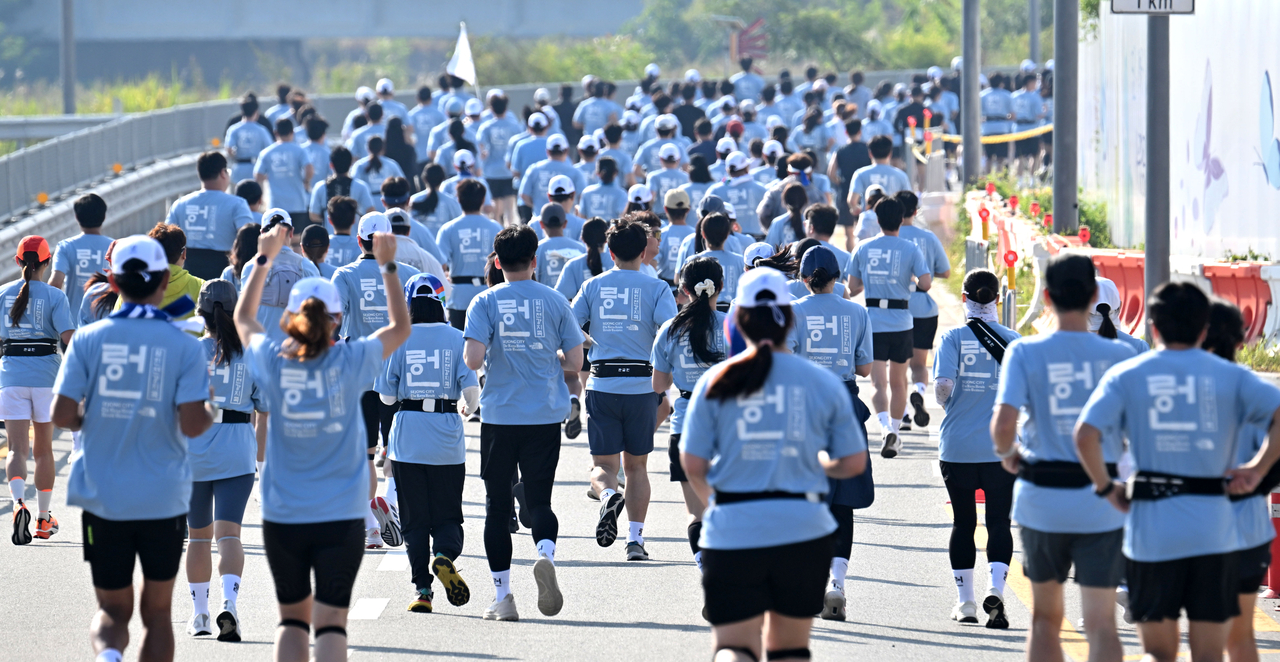 Participants gather at Sejong Central Park in Sejong on Friday to take part in the 2026 Hangeul Run, celebrating the 580th Hangeul Day and the 100th anniversary of the designation of Hangeul Day. (Im Se-jun/The Korea Herald)