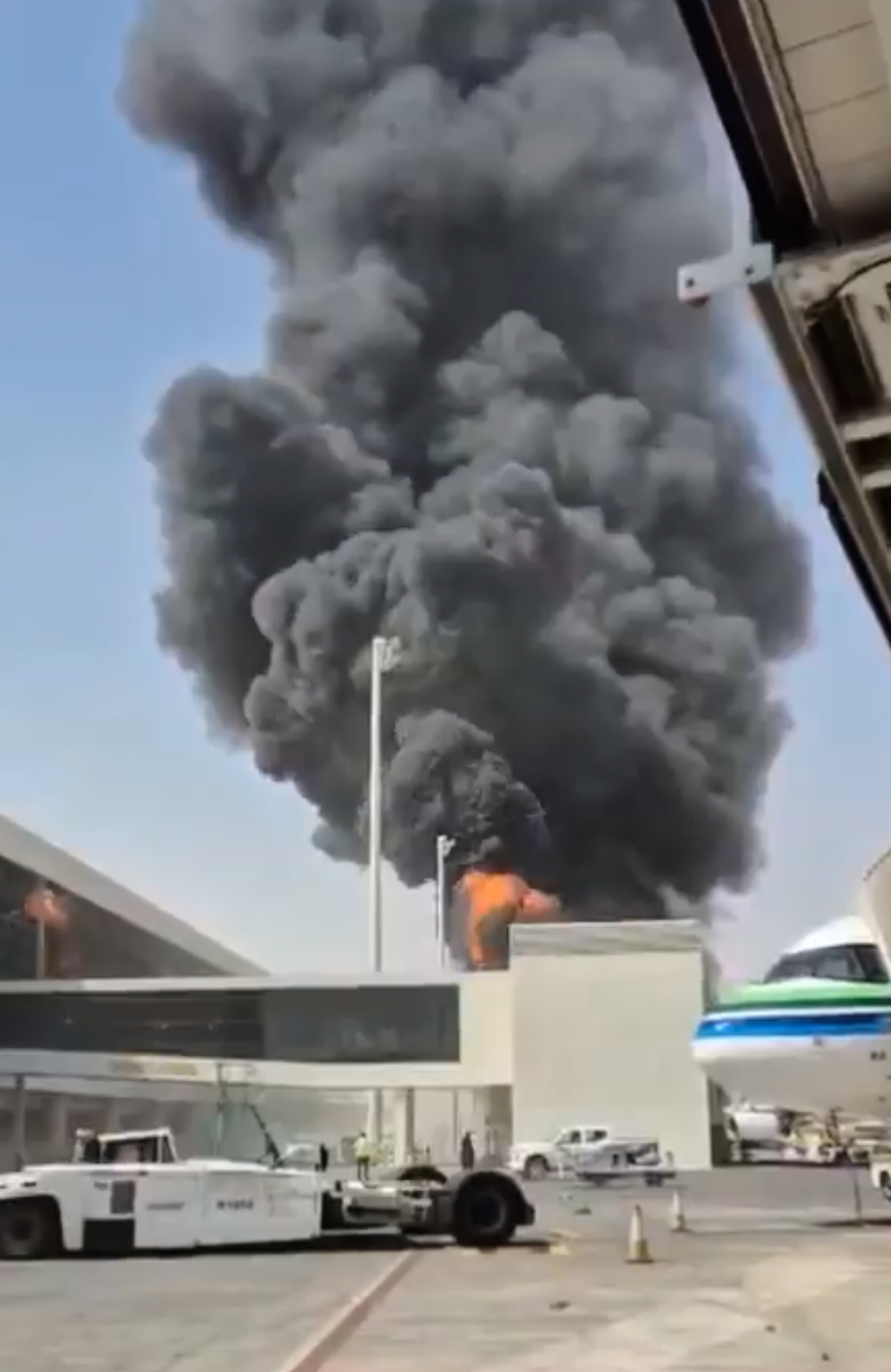Flames and smoke rise from King Khalid International Airport in Riyadh, Saudi Arabia, on Thursday. Three people were killed in the attack that day, including the captain of a Saudi civilian airline. [Reuters]