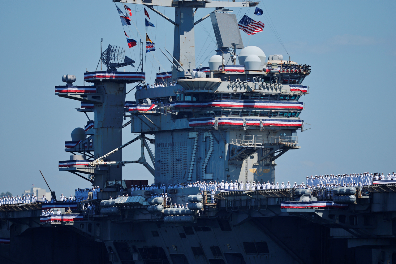 The USS Abraham Lincoln, a Nimitz-class aircraft carrier, returns to Naval Air Station North Island in Coronado, California, on Thursday after completing a lengthy deployment in the Middle East. [Reuters]