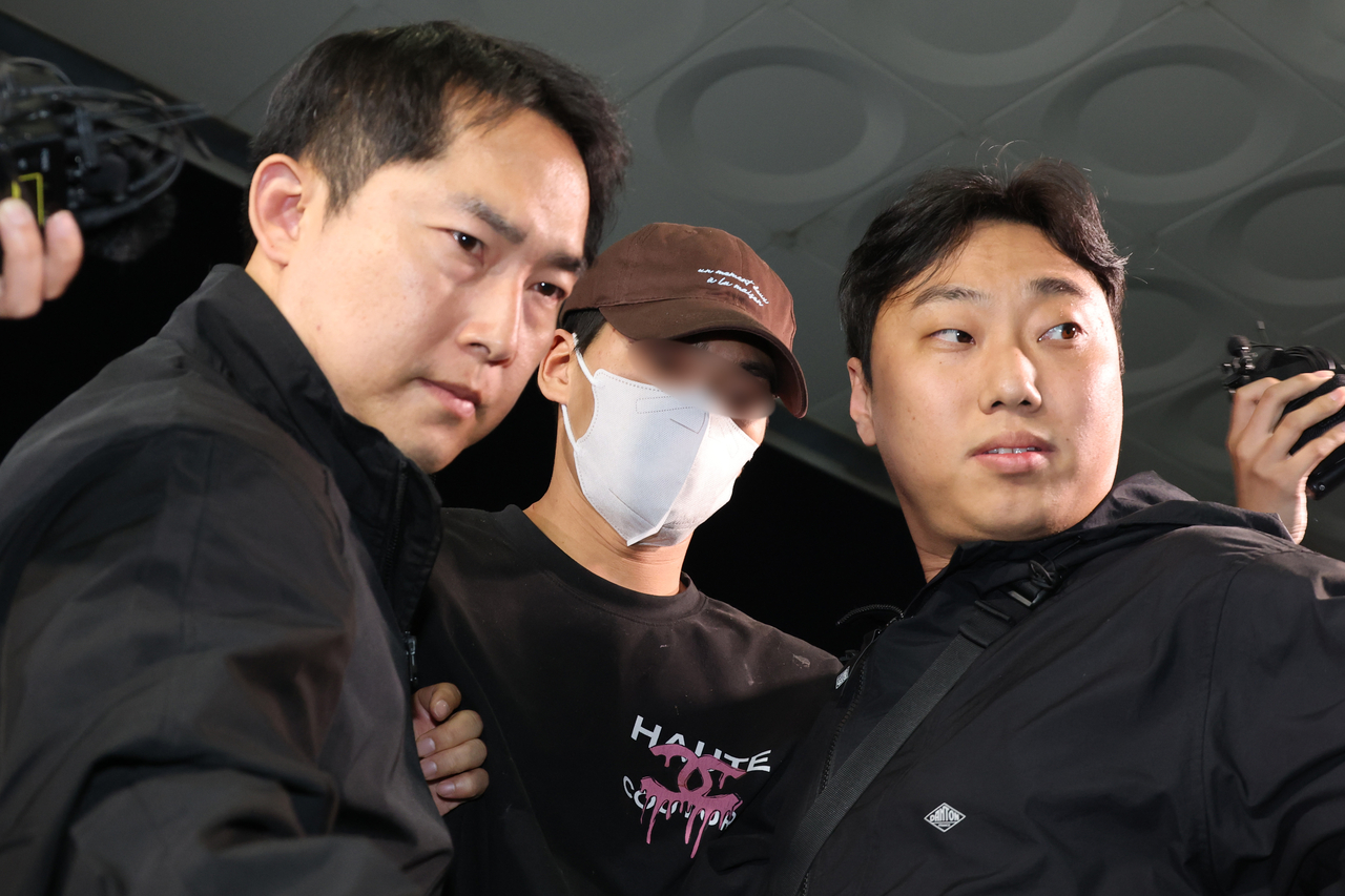 이혼소송 중 장모 살해 및 아내를 납치한 20대 중반 남성 김씨가 지난 11일 서울 송파경찰서로 압송되고 있다. [연합]
