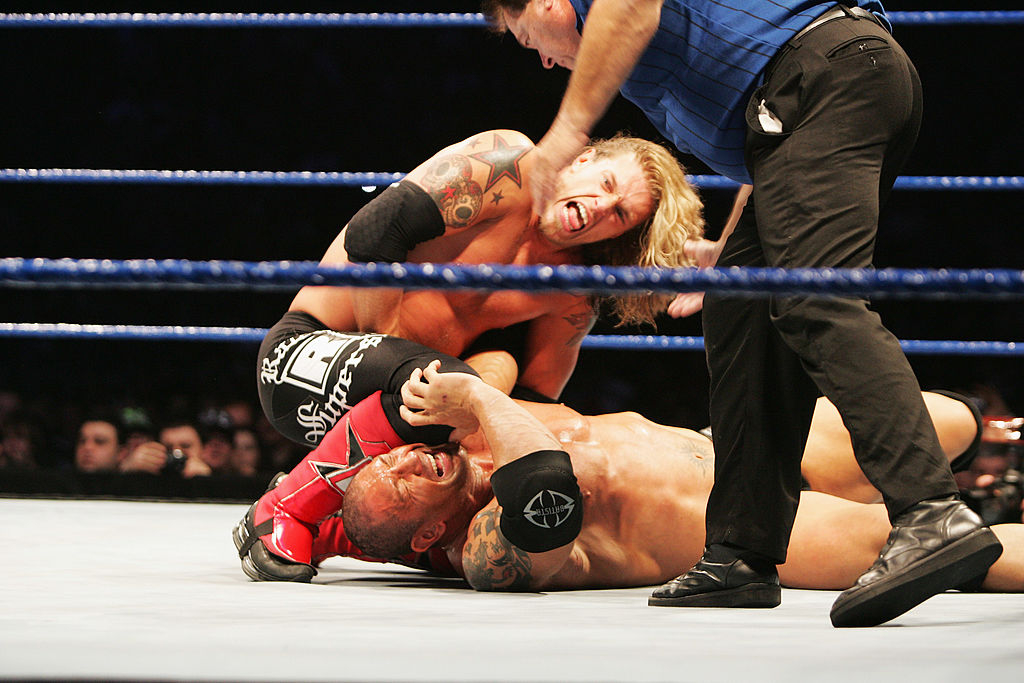 Edge (top left) strikes Batista with a knee to the head during WWE SmackDown at Acer Arena in Sydney, Australia, in June 2008. [Getty Images]