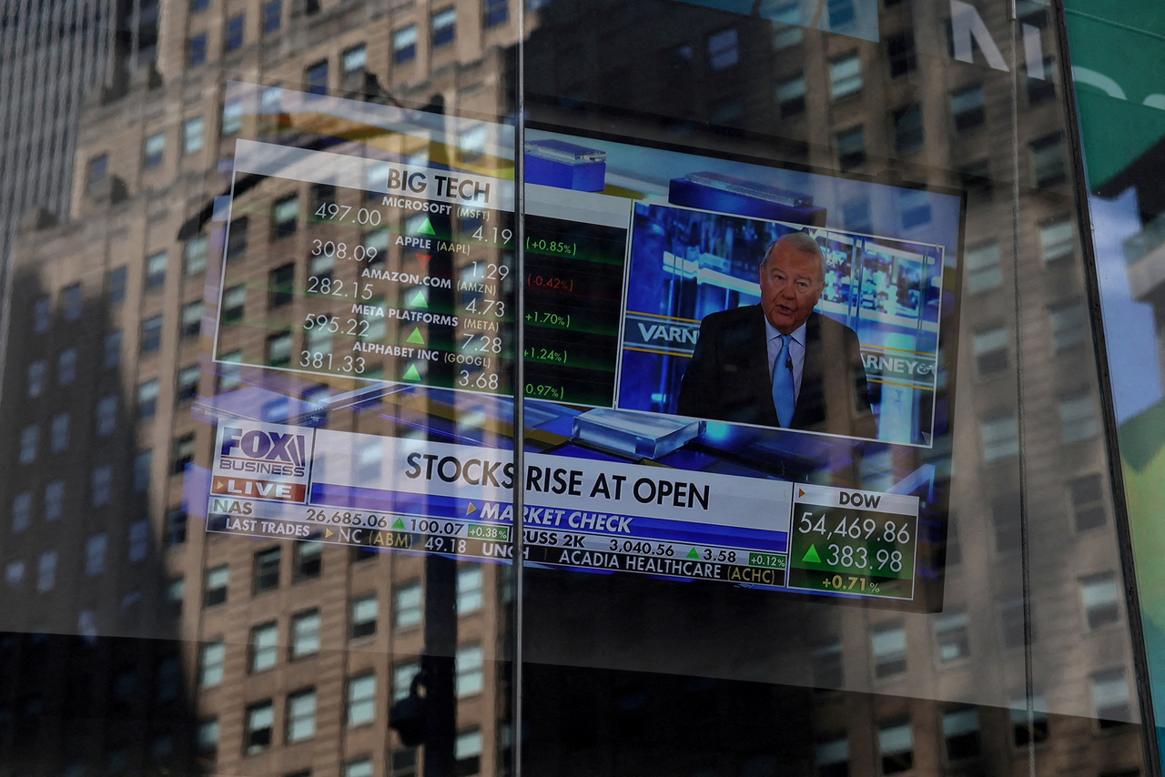Stock market data is displayed on an outdoor screen at the Nasdaq MarketSite in New York. [Reuters]