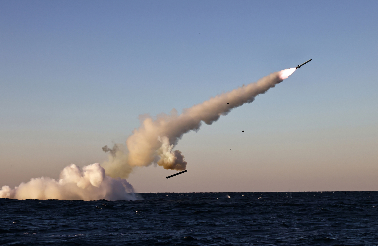 This photo, carried by North Korea's official Korean Central News Agency on Oct. 15, 2026, shows the North firing two types of strategic cruise missiles from a submarine the previous day. (Yonhap)