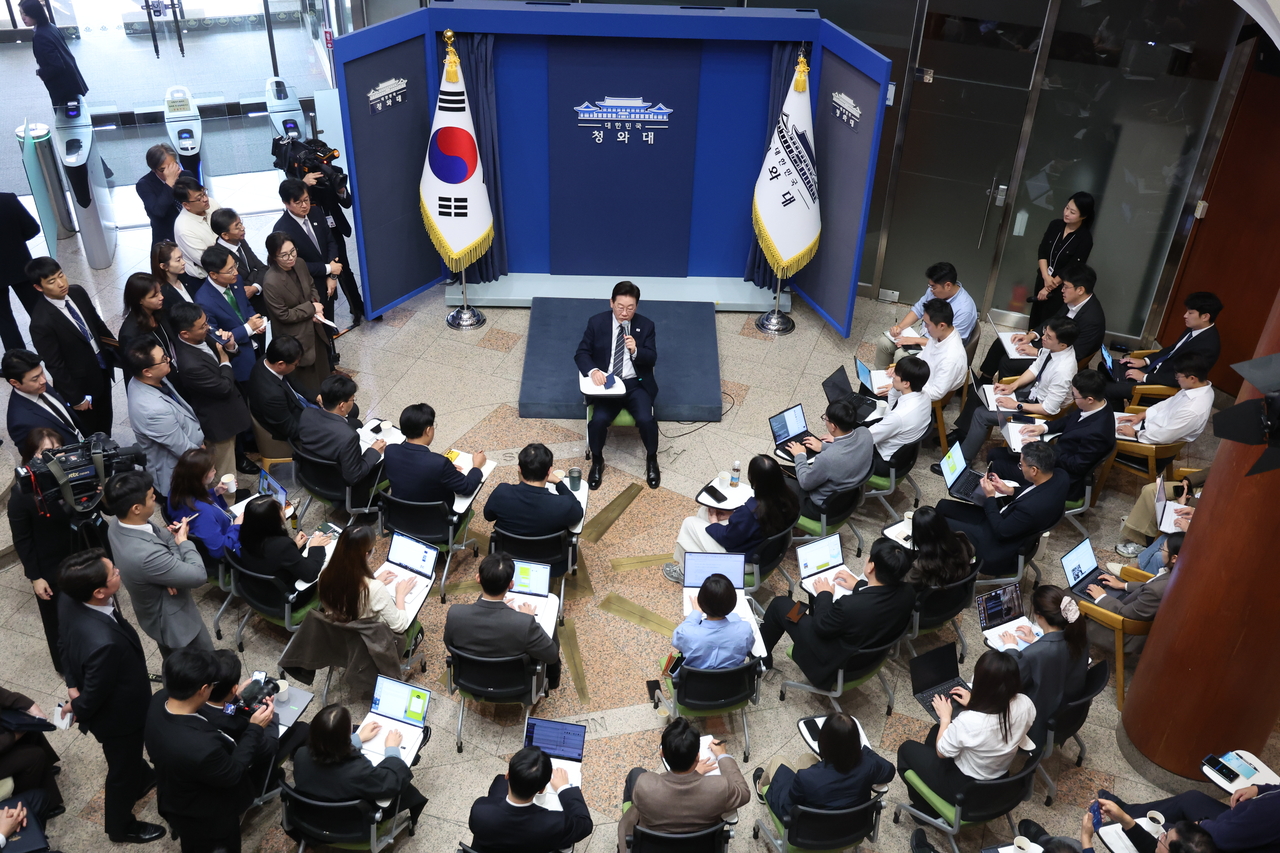President Lee Jae Myung speaks to reporters at Chunchugwan, the presidential press center, in the Cheong Wa Dae compound on Monday. (Pool photo via Yonhap)
