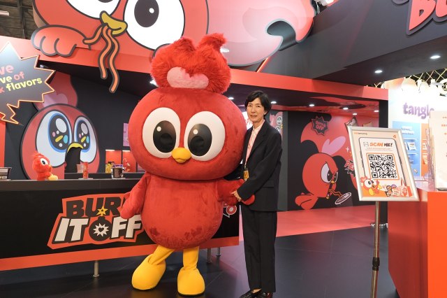 Samyang Foods Chairperson Kim Jung-soo poses with the company’s Buldak mascot at SIAL Paris 2026 in Paris Nord Villepinte on Saturday. (Samyang Foods)