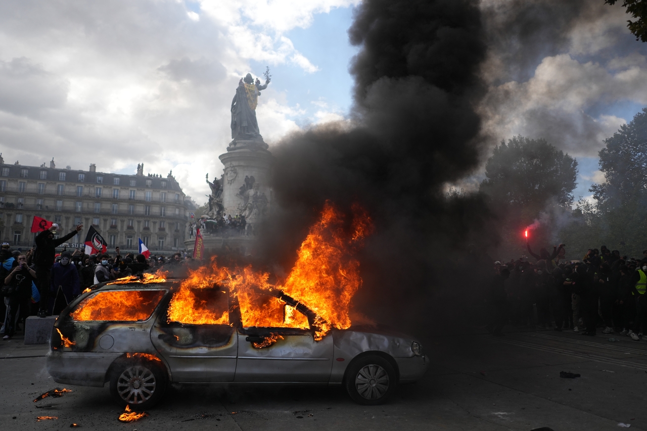 A car burns at Republique square during a protest against rising living costs, joining students' grievances, in Paris, Saturday. (AP-Yonhap)