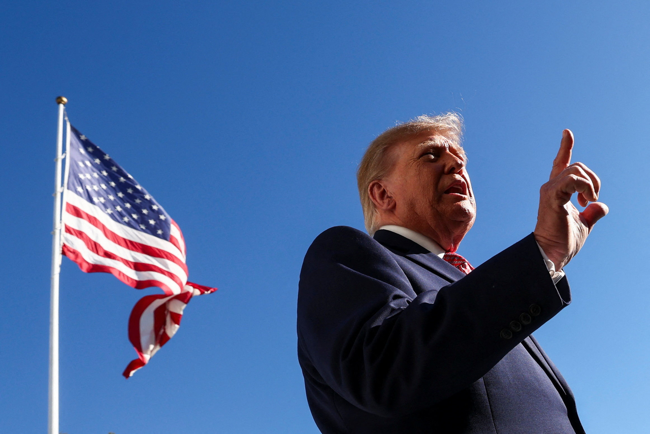 US President Donald Trump speaks to members of the media as he departs the White House en route to Kansas, in Washington, Monday. (Reuters-Yonhap)