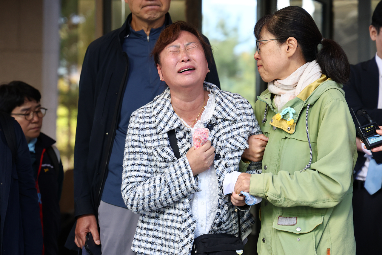 Lee Soon-hee (center), the mother of a victim of the Aricell factory fire, cries outside the Supreme Court on Tuesday after the court delivered its final ruling in the case against Aricell CEO Park Soon-kwan. (Yonhap)