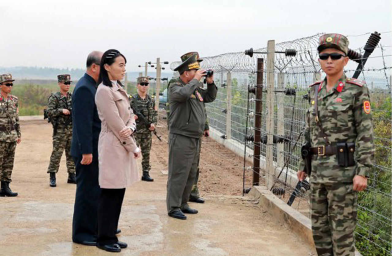 North Korean military and party officials, including leader Kim Jong-un's sister Kim Yo-jong, inspect a border fortification site on Tuesday, in this photo released by the Korean Central News Agency the following day. (KCNA-Yonhap)