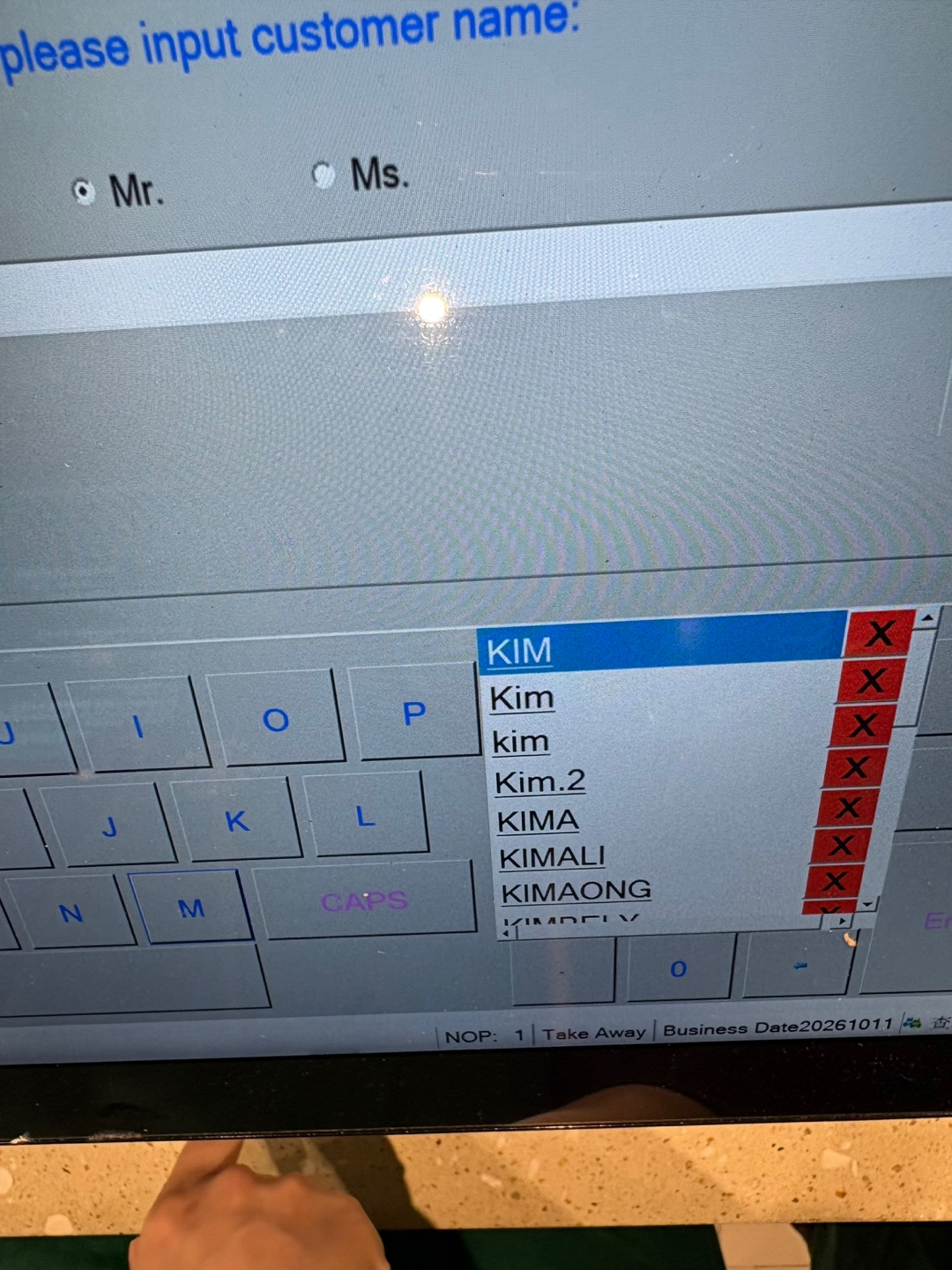 A register's screen shows that more input may be required to type in "Kimchi" from "Kim." (Kim)