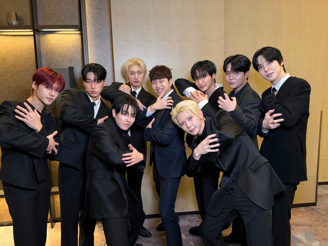 You Jae-phil (center) poses with Ateez during the group's showcase for its 13th EP, "Golden Hour: Part 4," in Seoul, Feb. 5. (You Jae-phil)