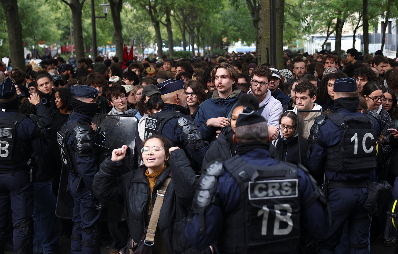 Demonstrators take part in a protest organized by student groups and trade unions in Paris on Thursday. [Reuters]