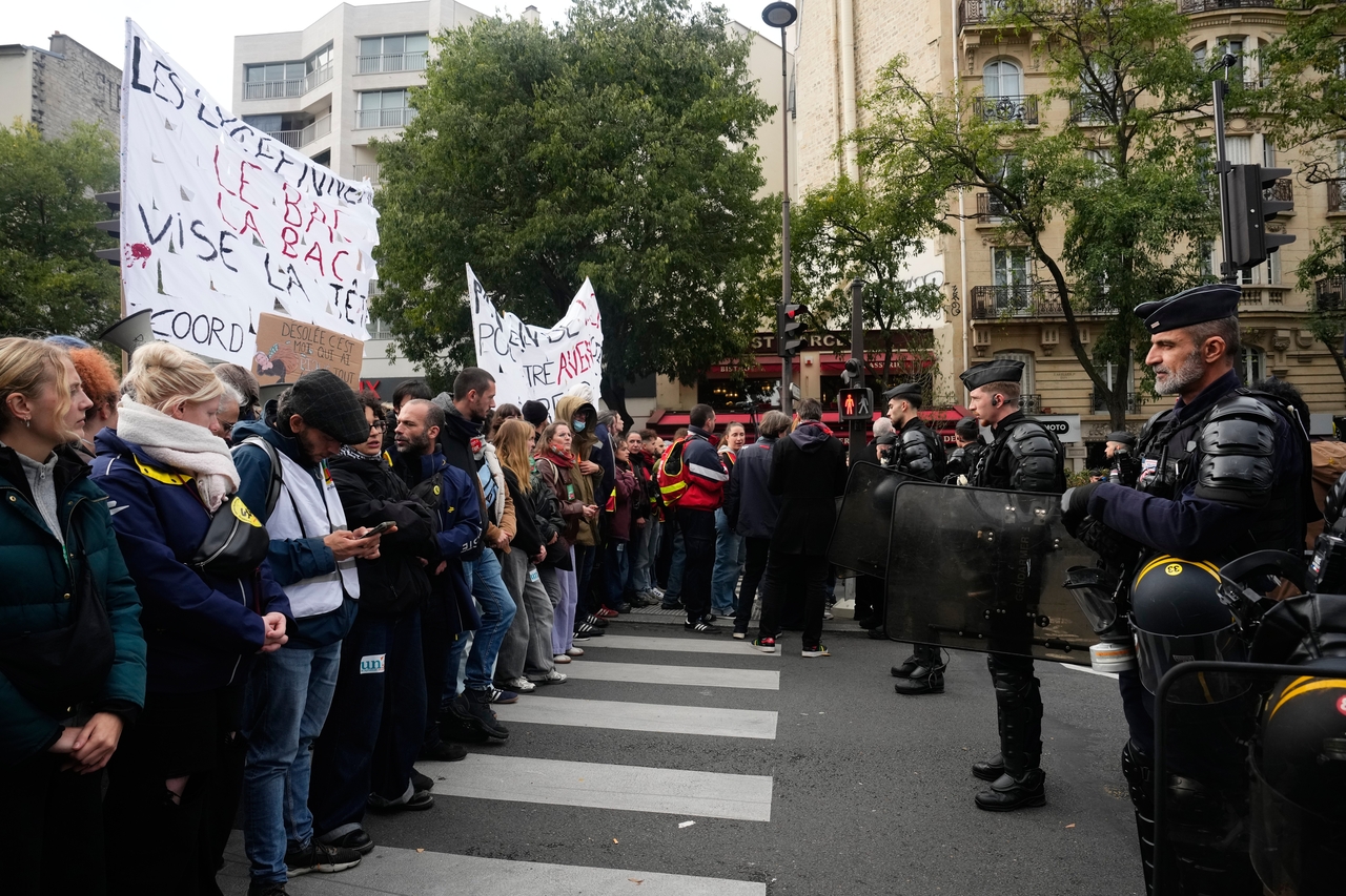 Police face demonstrators holding a banner reading "High schoolers are targeted by the Bac exam, the BAC brigade targets their heads" during a rally calling for better educational conditions in Paris on Thursday. [AP]
