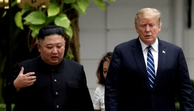 US President Donald Trump (right) and North Korean leader Kim Jong-un speak as they leave their summit in Singapore in June 2018. [Reuters]