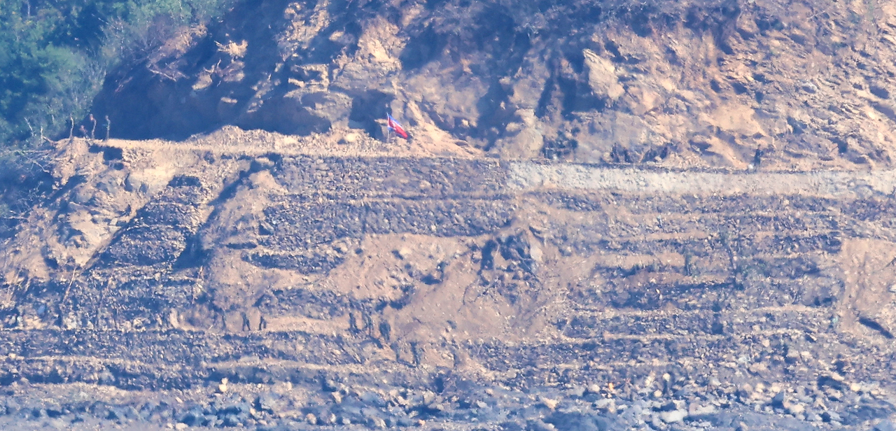 North Korean soldiers work on what appears to be a mission to construct tactical roads and fences near a border area, seen from South Korea's western border island of Ganghwa, in this photo taken Thursday. (Yonhap)