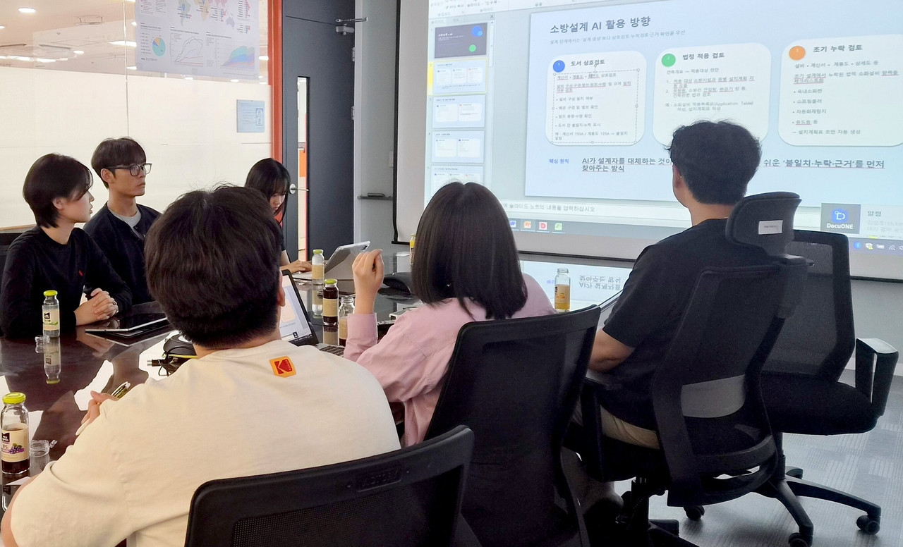 Students at Korea Fire Safety Meister High School hold a development meeting for their AI tool.